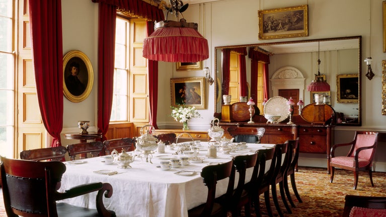 The dining room at The Argory (Co Armagh, Northern Ireland) features a table set with family china and silver for tea, traditionally the family's occasion for entertaining.